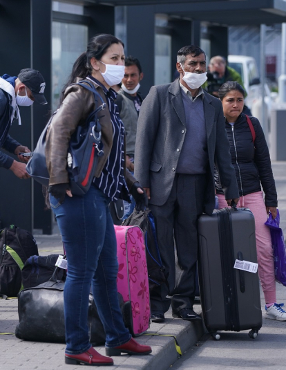 Seasonal workers from Romania board wait to board buses after arriving on a chartered flight at Schoenefeld Airport during the coronavirus crisis on April 09, 2020 in Schoenefeld, Germany.