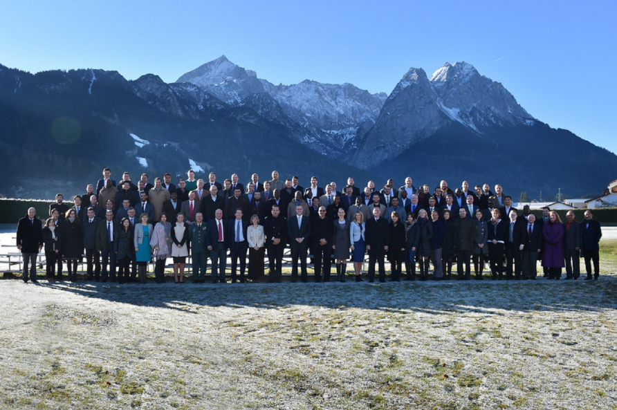 A photograph of students attending a PCSS course with the Zugspitze Mountain in the background.