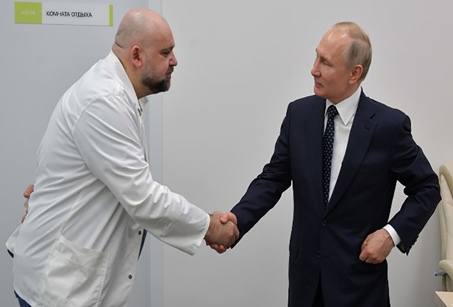 A photograph of Russian President Vladimir Putin shaking hands with the head of Moscow's new hospital treating coronavirus patients during his visit to Kommunarka hospital in Moscow, Russia.