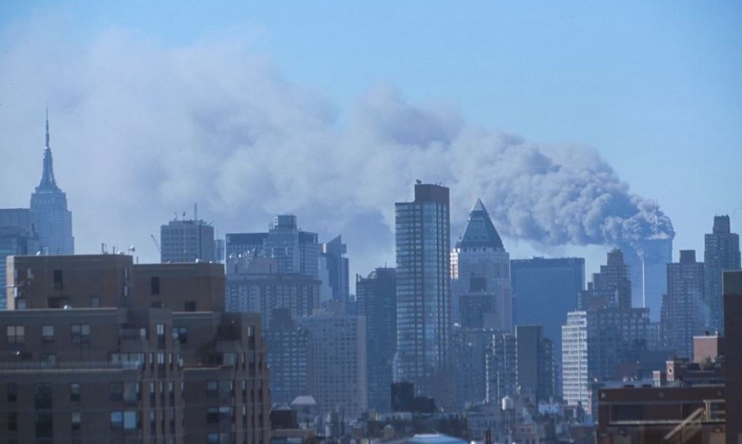 Skyline of Manhattan with smoke billowing from the Twin Towers following September 11th terrorist attack on World Trade Center, New York City, 2001 Sept. 11.