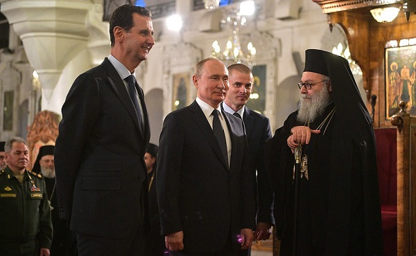 Vladimir Putin at the Orthodox Mariamite Cathedral of Damascus, with Patriarch John X of Antioch and All the East. Left, Syrian President Bashar al-Assad, January , 2020.