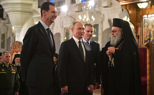 Vladimir Putin at the Orthodox Mariamite Cathedral of Damascus, with Patriarch John X of Antioch and All the East. Left, Syrian President Bashar al-Assad, January , 2020.