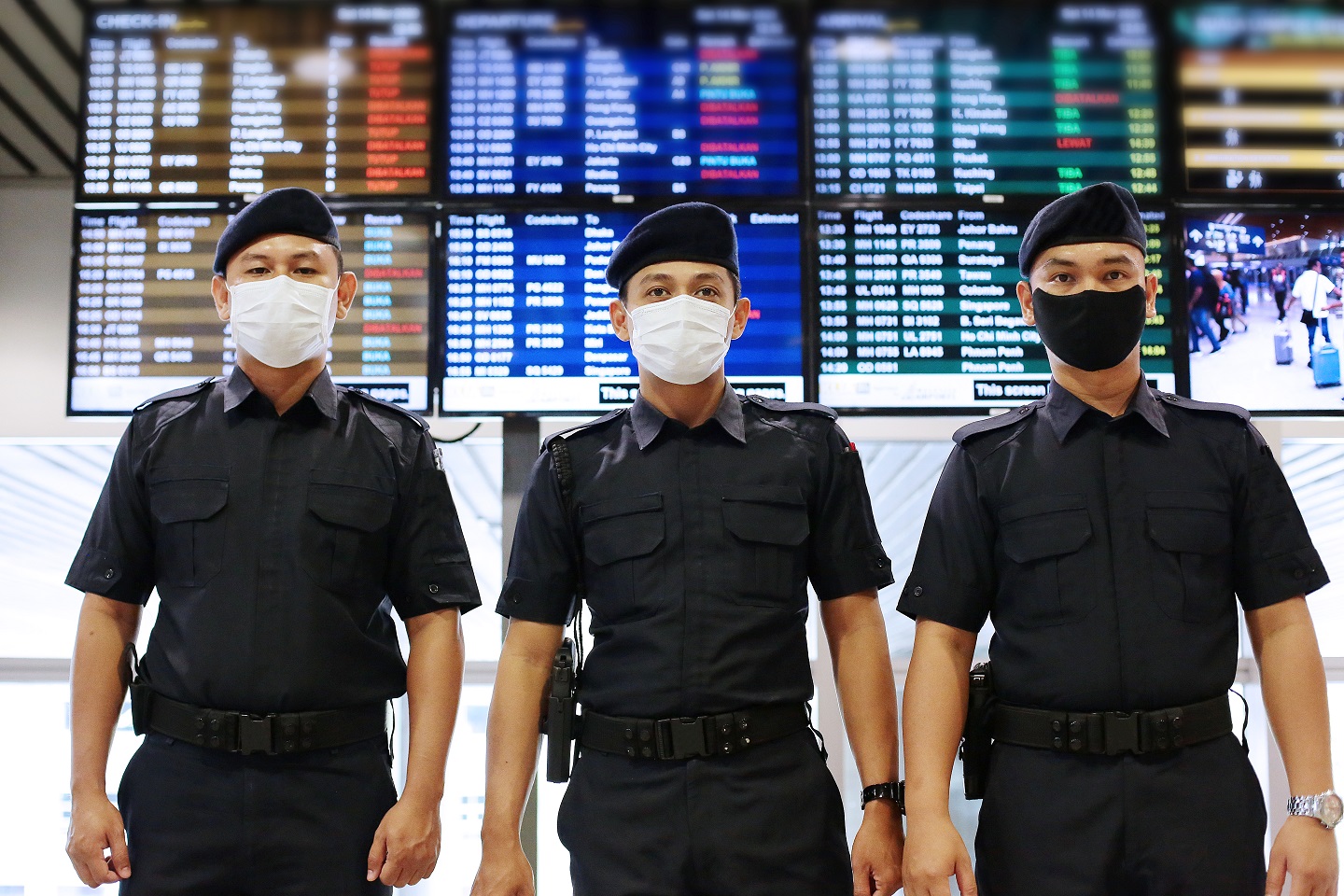 Malaysian Police at the Airport - in COVID-19 Masks