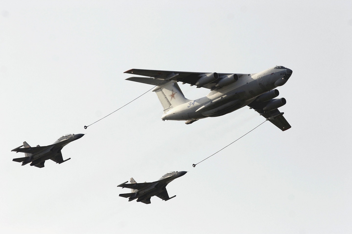 A photograph of Chinese fighter jets refueling in the air.