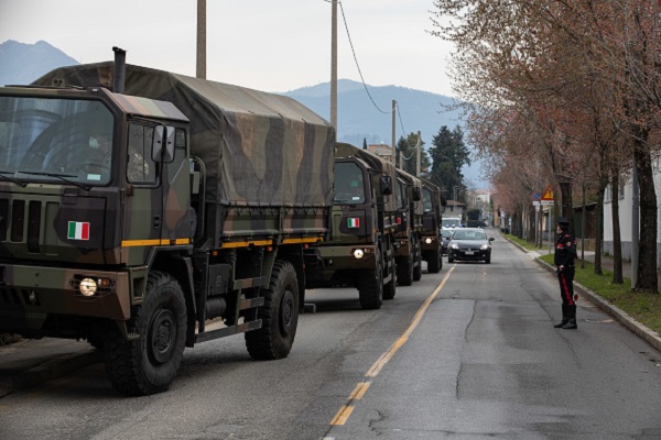 BERGAMO, ITALY - MARCH 26: A convoy of military vehicles arrives at the Monumental Cemetery on March 26, 2020 in Bergamo, near Milan, Italy. The Italian Army has been brought in to ferry coffins out of Bergamo, amongst Italy's most plagued towns, as its morgue and its crematorium struggle to cope with the surging coronavirus death toll. The Italian government continues to enforce the nationwide lockdown measures to control the spread of COVID-19.