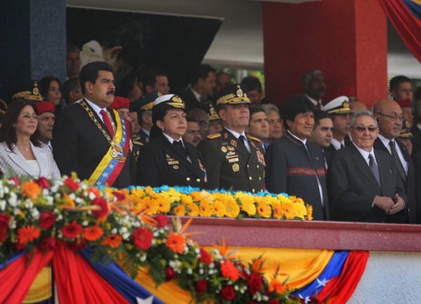 Venezuelan President Nicolas Maduro (L), stands with his military chiefs and honored guests Bolivian President Evo Morales (2nd R) and Cuban President Raul Castro (R) at an event marking the first anniversary of Hugo Chavez's death on March 5, 2014 in Caracas, Venezuela.