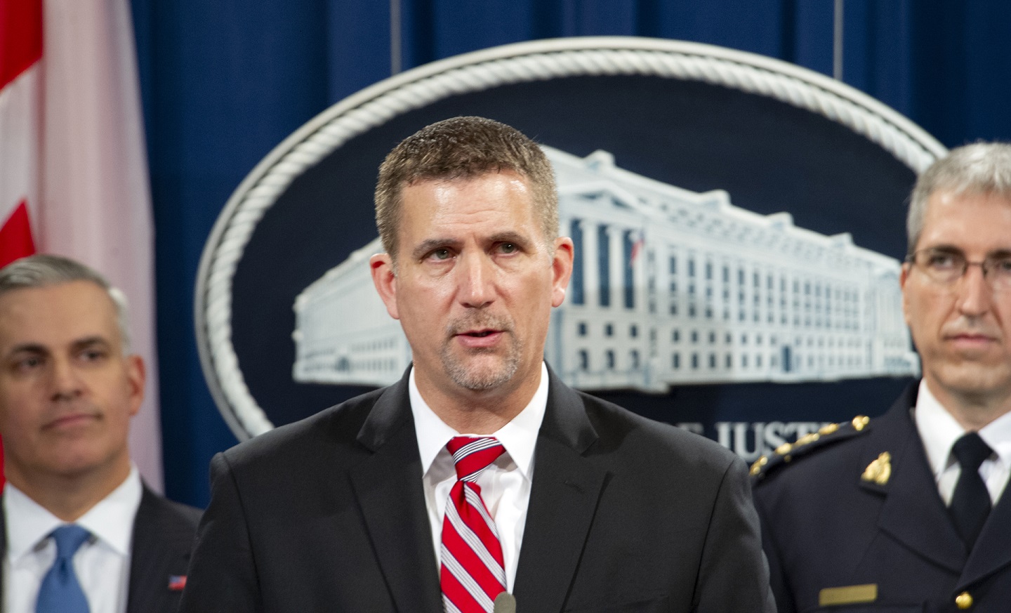A photograph of FBI Cyber Division Deputy Assistant Director, Eric Welling, speaking at the Department of Justice in Washington, D.C.