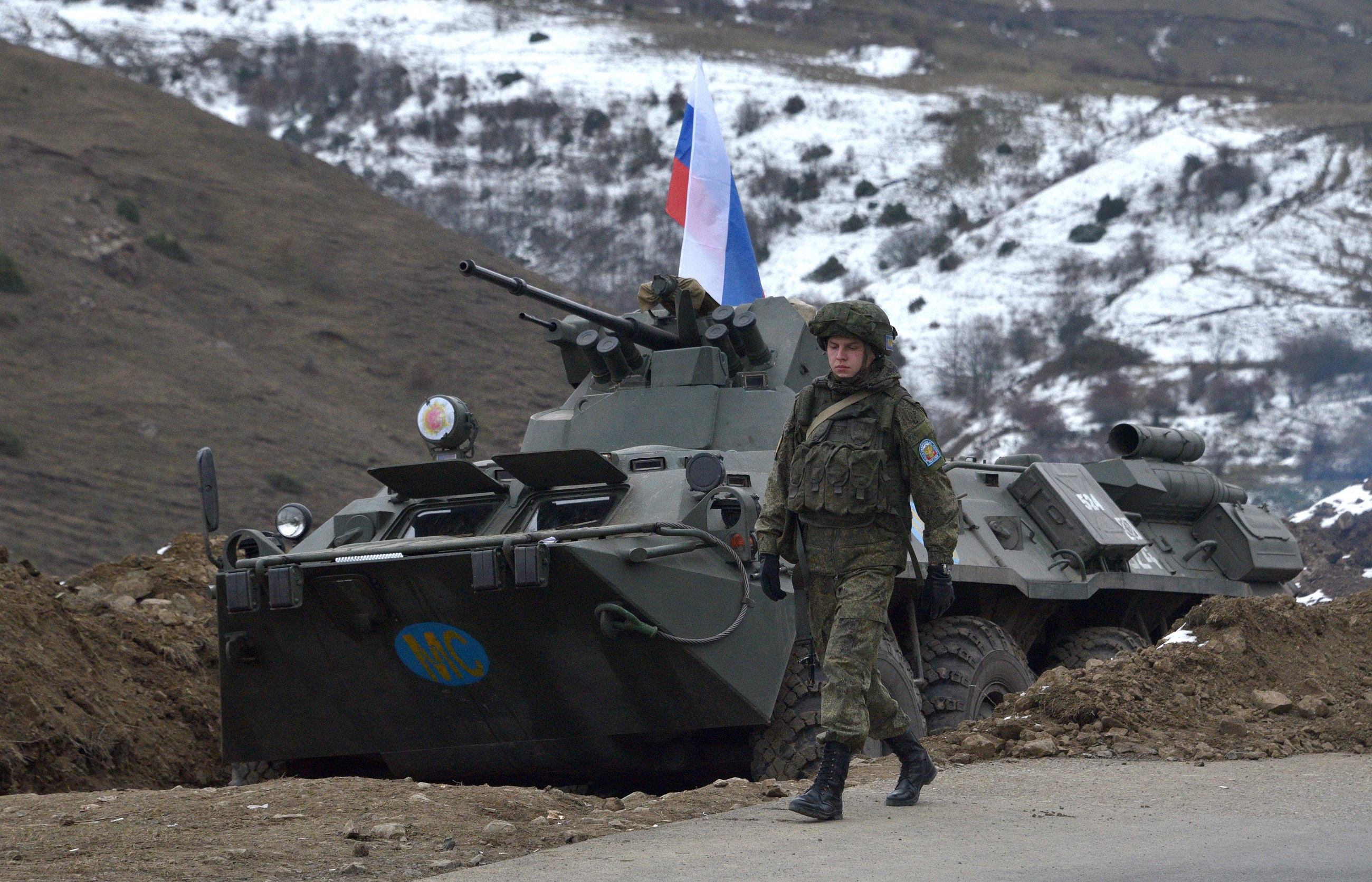 Russian soldiers of the peacekeeping force man a checkpoint on a road outside the town of Stepanakert on November 26, 2020, after six weeks of fighting between Armenia and Azerbaijan over the disputed Nagorno-Karabakh region.