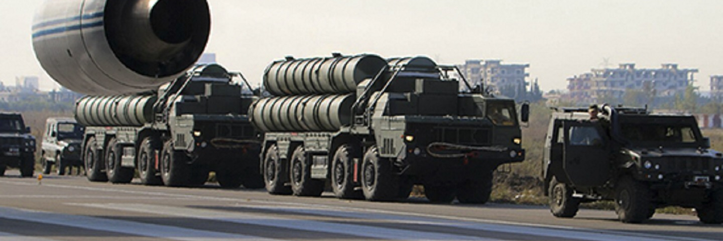 Russian military vehicles loading wepons to an airplane.