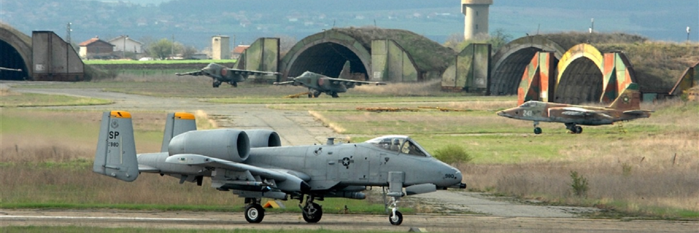 BEZMER AIR BASE, Bulgaria -- An 81st Fighter Squadron A-10 "Warthog" taxis down the runway to take off on a training mission with Bulgarian SU-25s parked in the background at Bezmer Air Base, Bulgaria. The Spangdahlem A-10s deployed here to support Reunion April 2009, a U.S. and Bulgarian Air Forces joint training exercise, August 26,2011. (DOD photo by Air Force Master Sgt. Bill Gomez)
