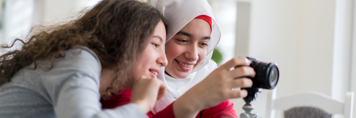 A photograph of two young girls looking a at a camera.