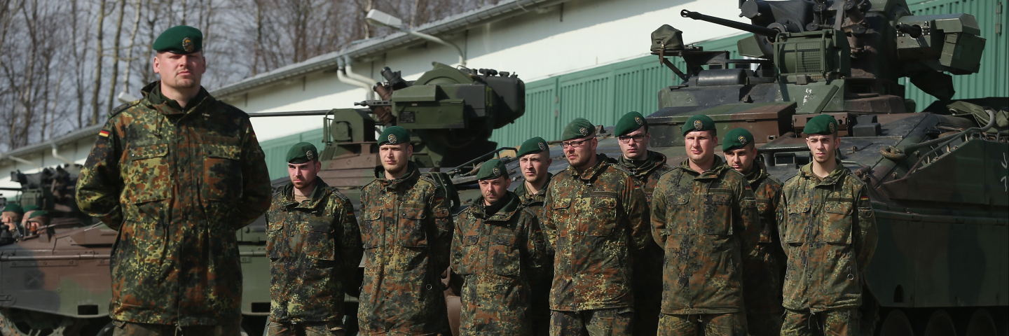 MARIENBERG, GERMANY - MARCH 10: Members of the German Bundeswehr's 371st Armoured Infantry Battalion (Panzergredanadierbataillon 371) stand to attention with Marder light tanks during a media event at the battalion's base on March 10, 2015 in Marienberg, Germany.