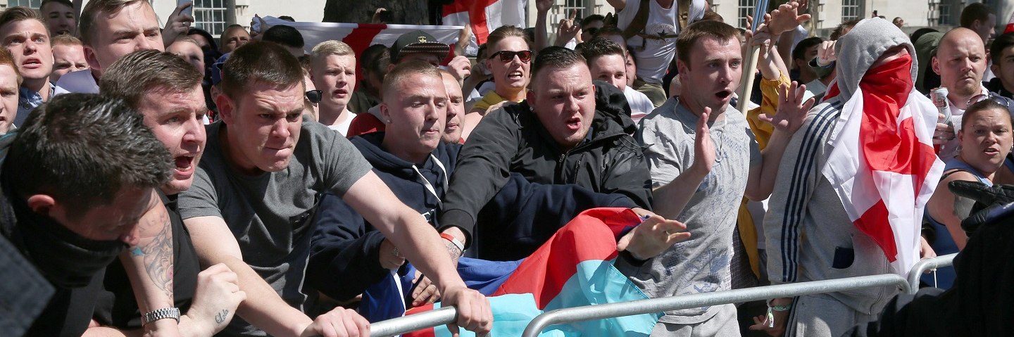English Defence League (EDL) supporters try to reach anti fascist protestors during a rally outside Downing Street on May 27, 2013 in London, England.