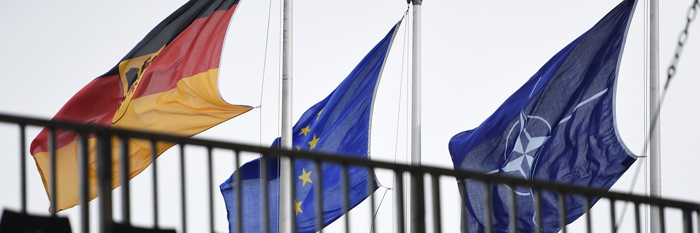 The Flags of Germany, the European Union and the NATO (North Atlantic Treaty Organization) hang during a military exercise on October 10, 2017 near Munster, Germany.