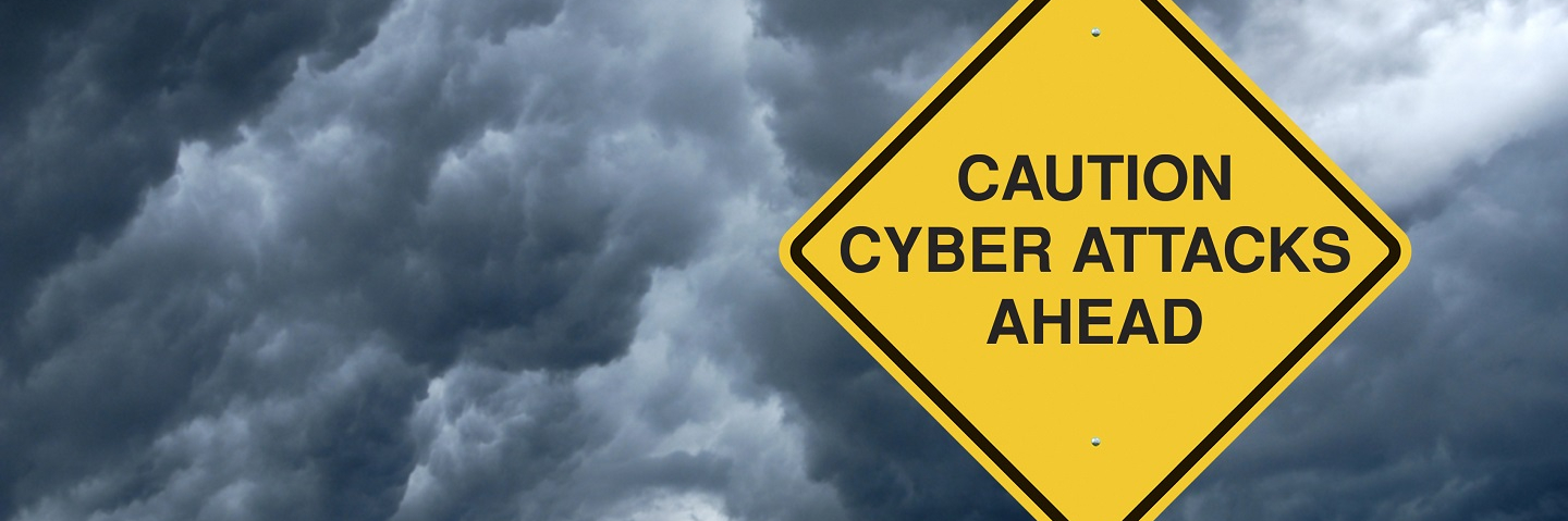 A Caution Sign in Front of Storm Clouds Warning of "Cyber Attacks Ahead."