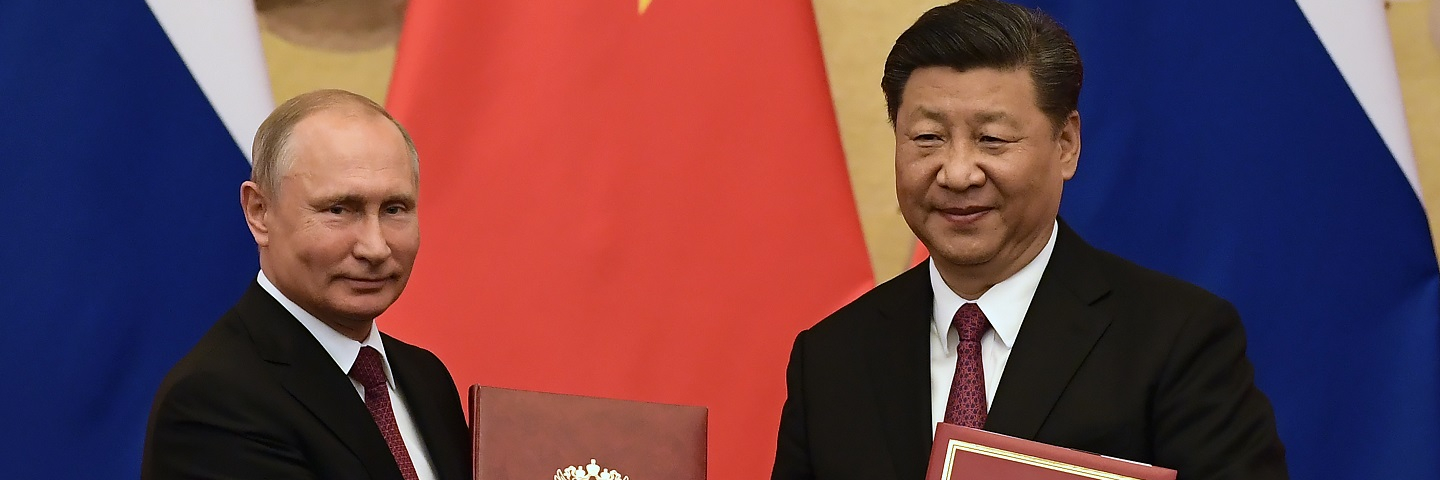 A photograph of Chinese President Xi Jinping congratulating Russian President Vladimir Putin after presenting him with the Friendship Medal in the Great Hall of the People on June 8, 2018 in Beijing, China.