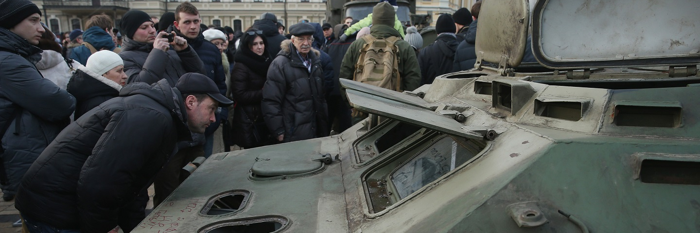 People look at the remains of an armoured personnel carrier that is part of an exhibition of weapons, drones, documents and other materials the Ukrainian government claims it recovered in eastern Ukraine and prove direct Russian involvement in the fighting between Ukrainian troops and pro-Russian separatists on February 22, 2015 in Kiev, Ukraine. Russia has denied sending heavy weaponry to the separatists, admitting only that Russian volunteers are participating in the fighting.