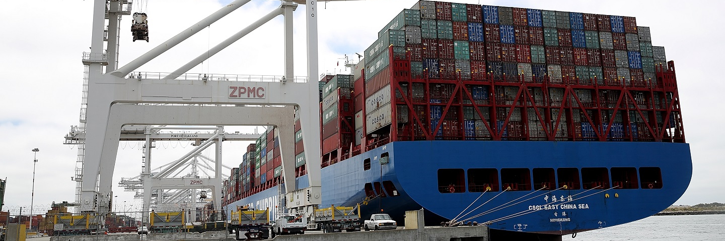 Photograph of a cargo ship full of cargo containers.