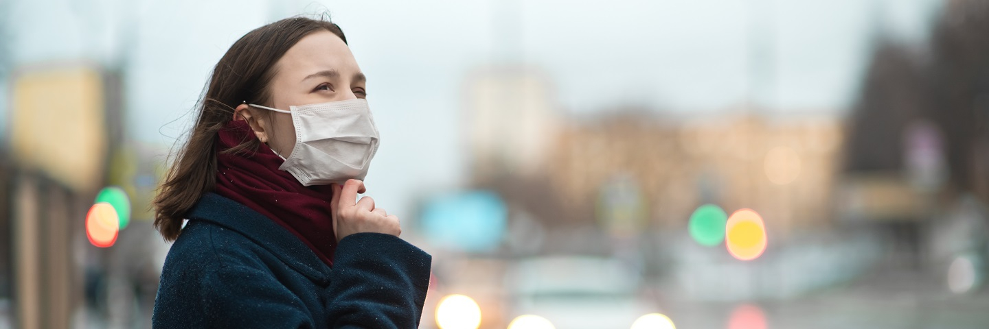 A photograph of a young girl wearing a protective face mask.