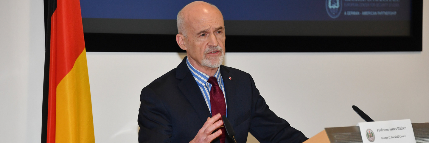 A photograph of Professor James Wither lecturing at a George C. Marshall Center course.