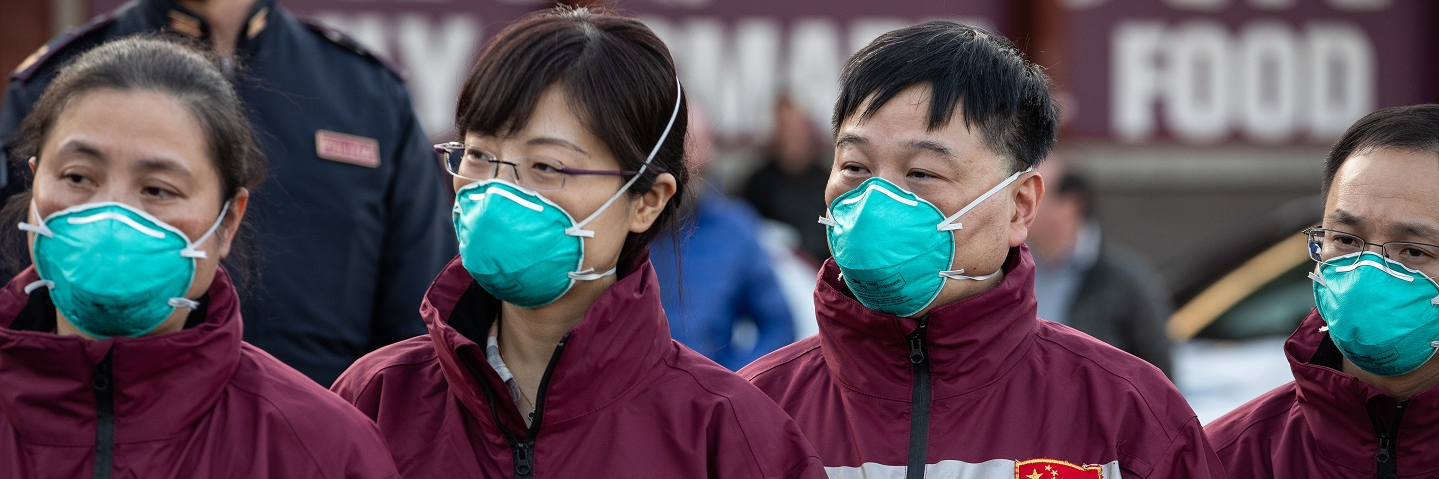 Members of a Chinese Anti-Epidemic medical expert team stand after landing at Milan - Malpensa airport on March 18, 2020 in Ferno, near Milan, Italy.