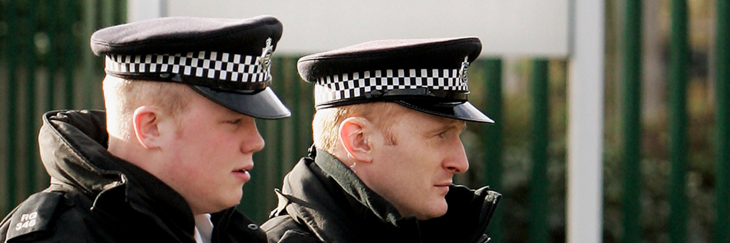 Armed police officers patrol near Woolwich Crown Court.