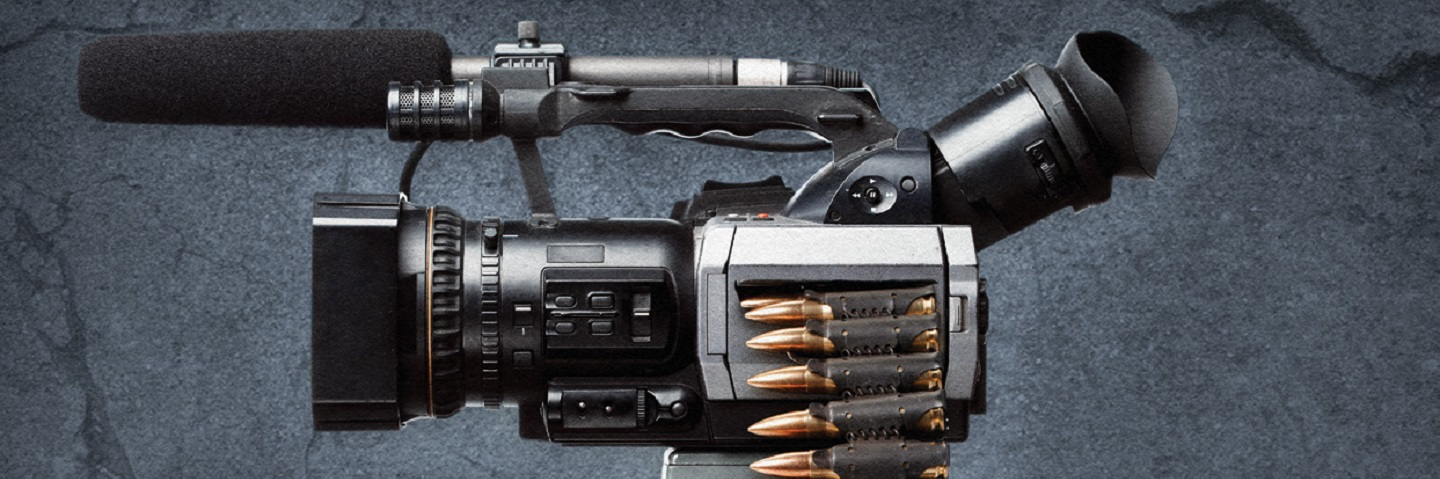 A photograph of a video camera with an ammo strip draped over the top.