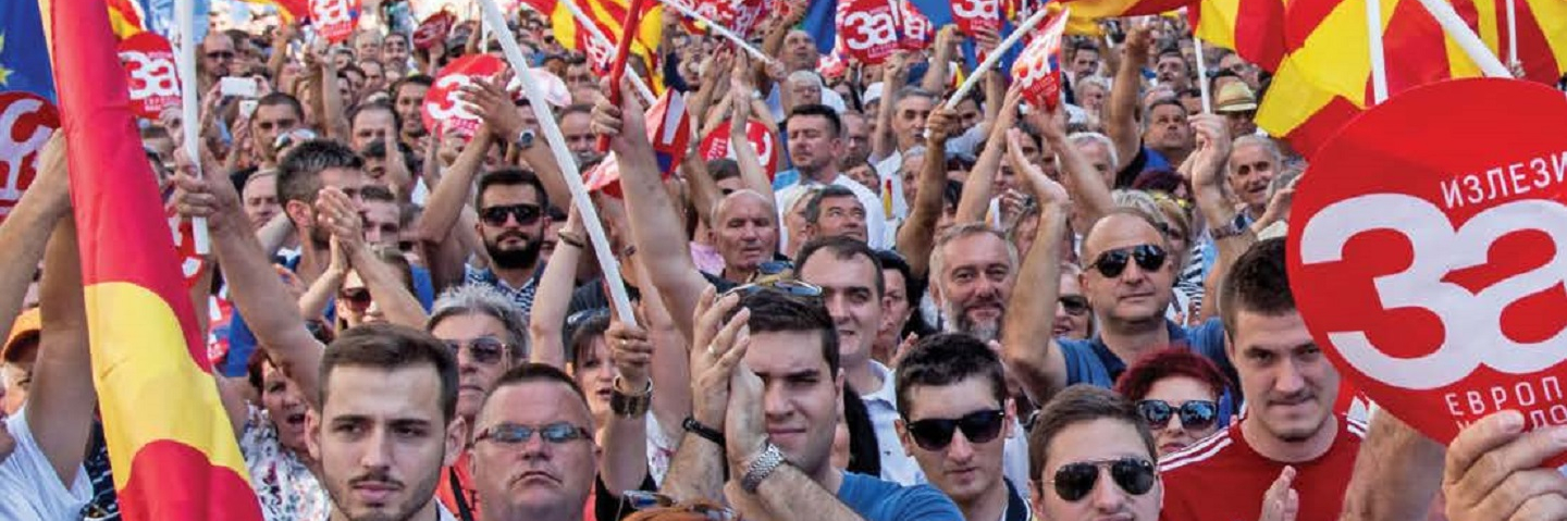 People in Skopje wave the Macedonian and European Union flags at a rally before a referendum in 2018 on whether to change the country's name to "Republic of North Macedonia."