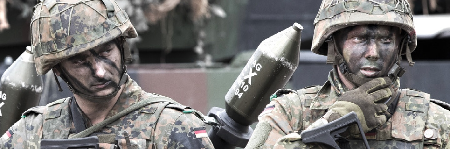 Two German Bundeswehr soldiers in uniform, with weapons.