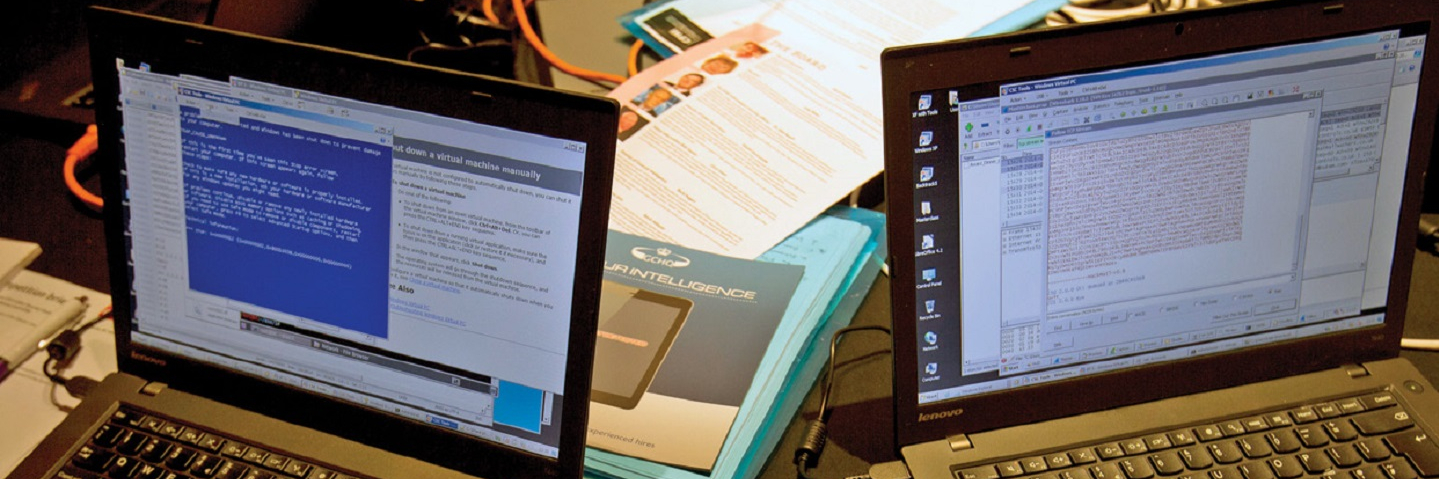 Two laptops and three hands