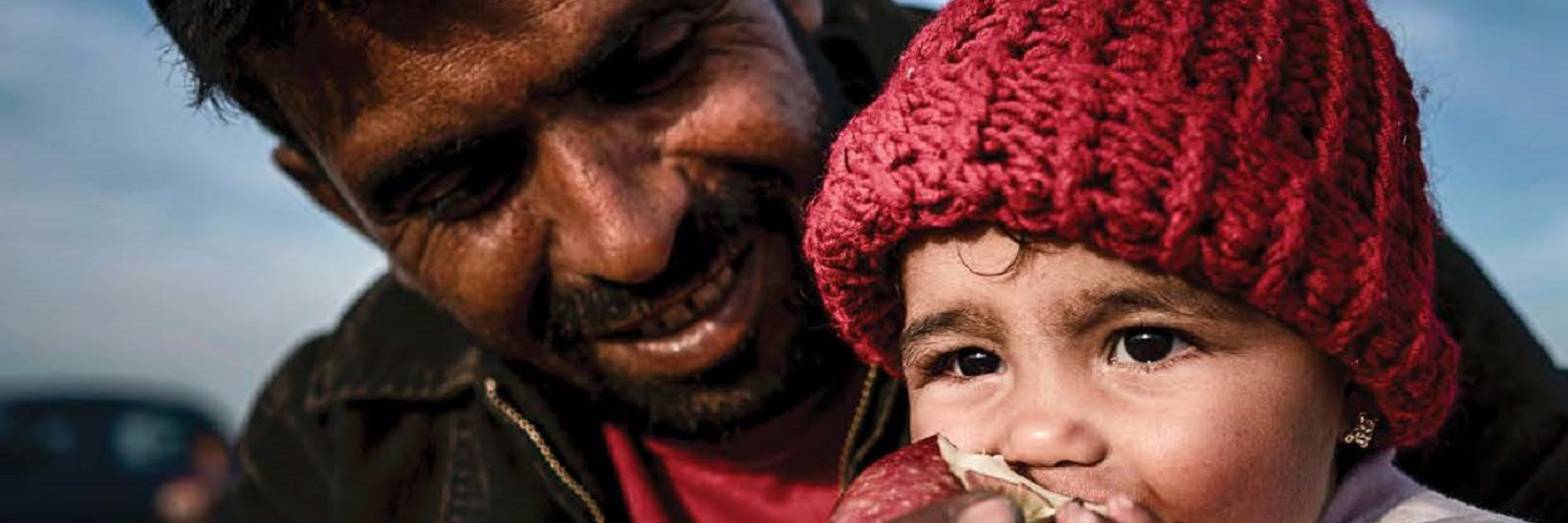 man giving baby an apple