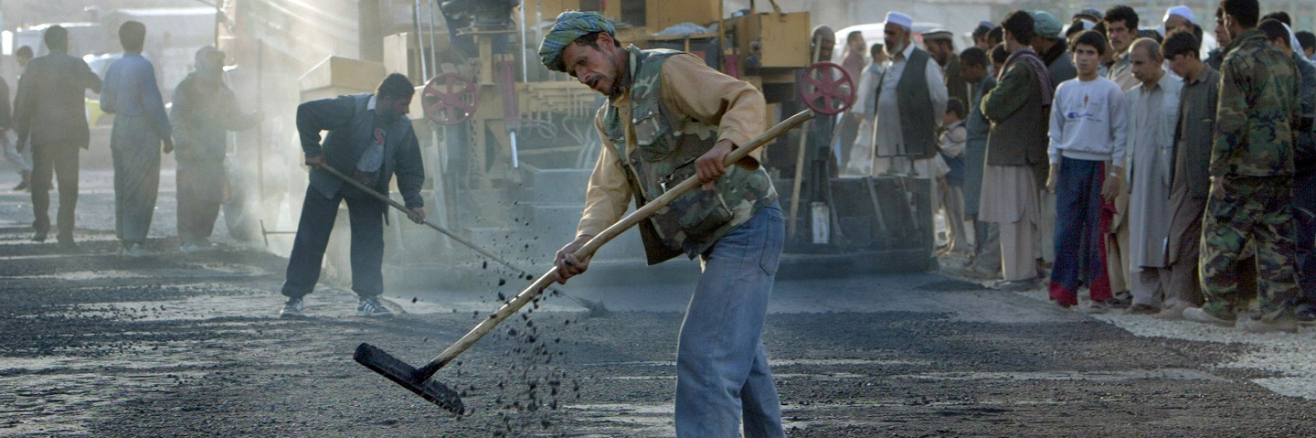 Afghan workers pave the road for a new traffic circle in Kabul, Afghanistan.