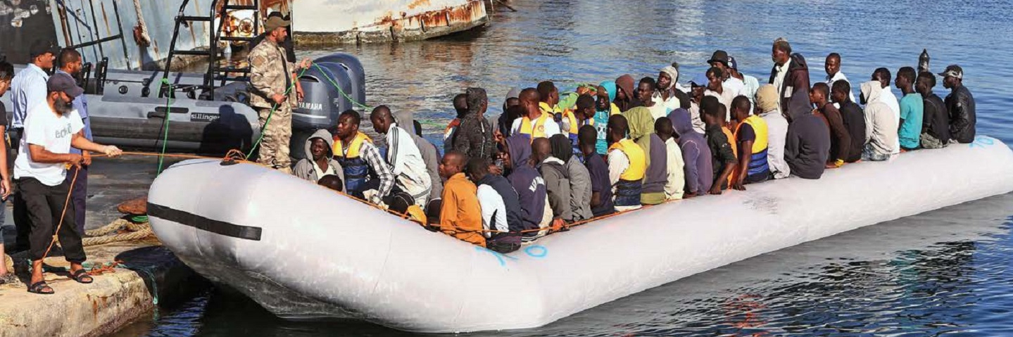 Refugees arriving in zodiac boat