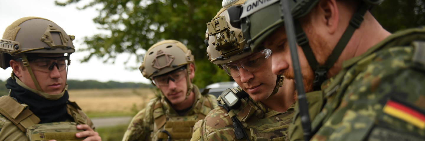 Explosive ordnance disposal technicians assigned to Explosive Ordnance Disposal Mobile Unit (EODMU) 8 get inbriefed on a homemade explosive cache by their German counterpart during exercise Northern Coasts in Putlos, Germany, Sept. 15, 2019