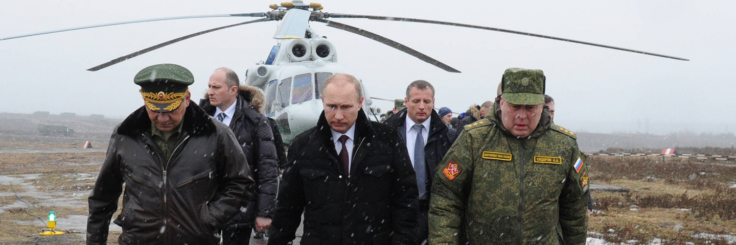 President Vladimir Putin (front C) and Defence Minister Sergei Shoigu (front L) walk to watch military exercises