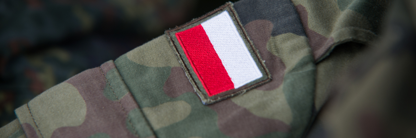 Red and white patch on military fatigues designating the solider as Polish.