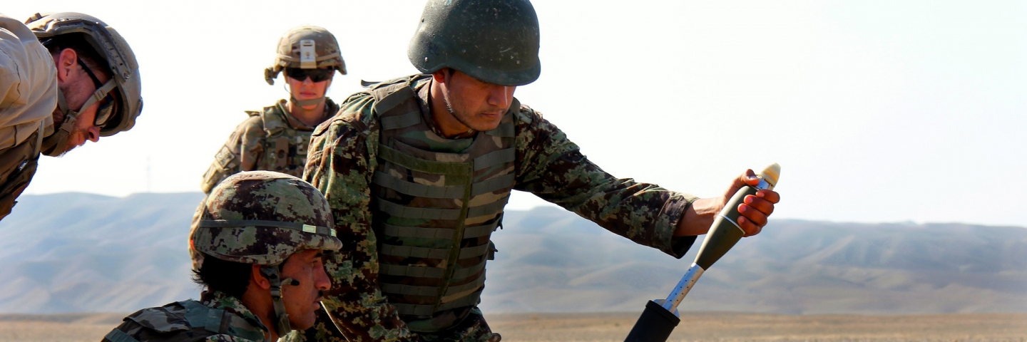 Afghan soldier prepares to load a round during mortar training taught by the Warrior Training Alliance on Tactical Base Gamberi, Afghanistan, Dec. 3, 2014.