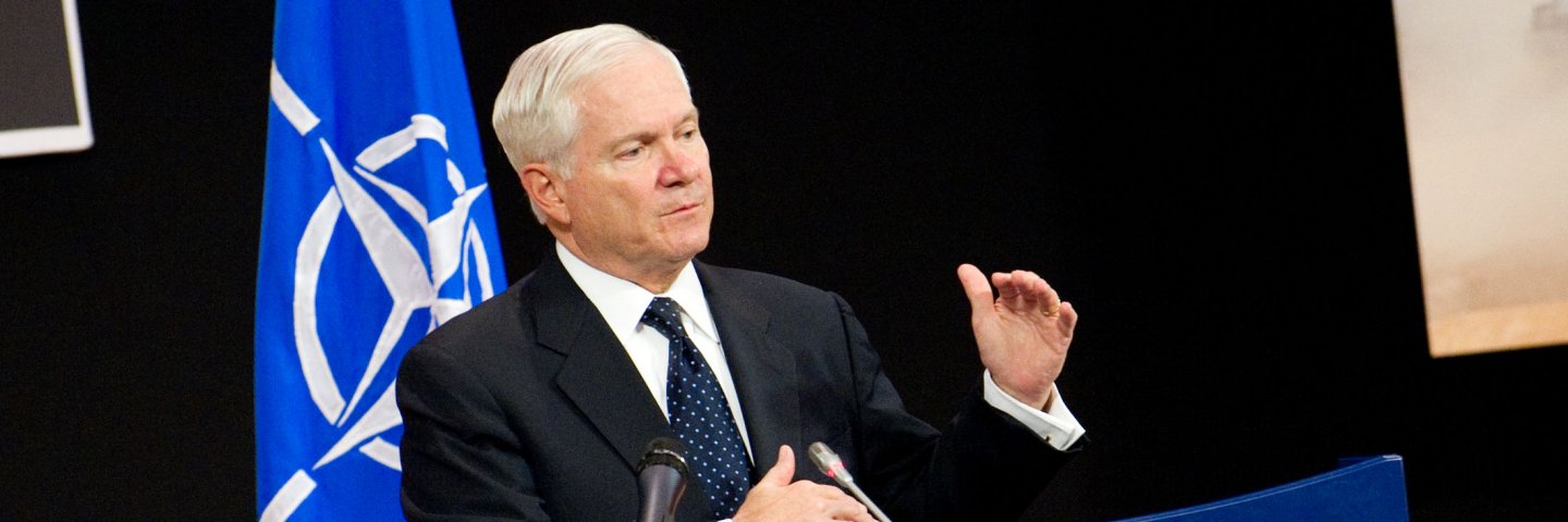 Photograph of then U.S. Secretary of Defense Robert Gates speaks at a Brussels defense conference in 2011 to persuade NATO members to finance the Alliance adequately or risk military decline.