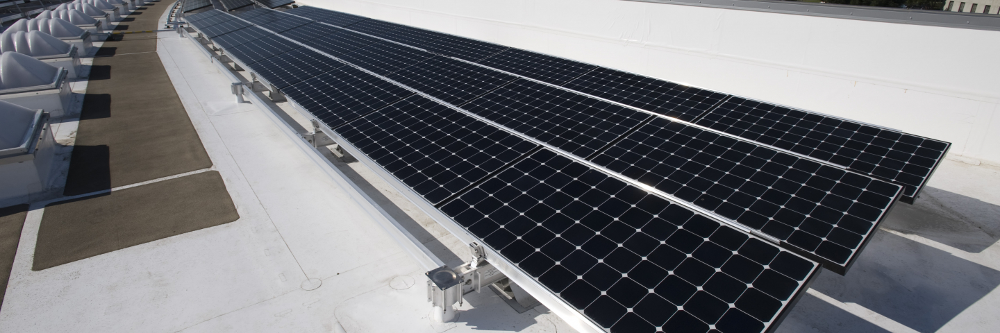 A photograph of solar panels on a roof.