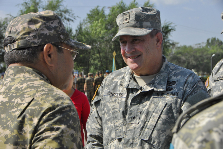 U.S. Brig. Gen. Kenneth Roberts, U.S. Army Central Command director of operations, right, is greeted by General-Lieutenant Saken Zhasuzakov, the Kazakh chief of defense, during the opening ceremony for Steppe Eagle 2013.