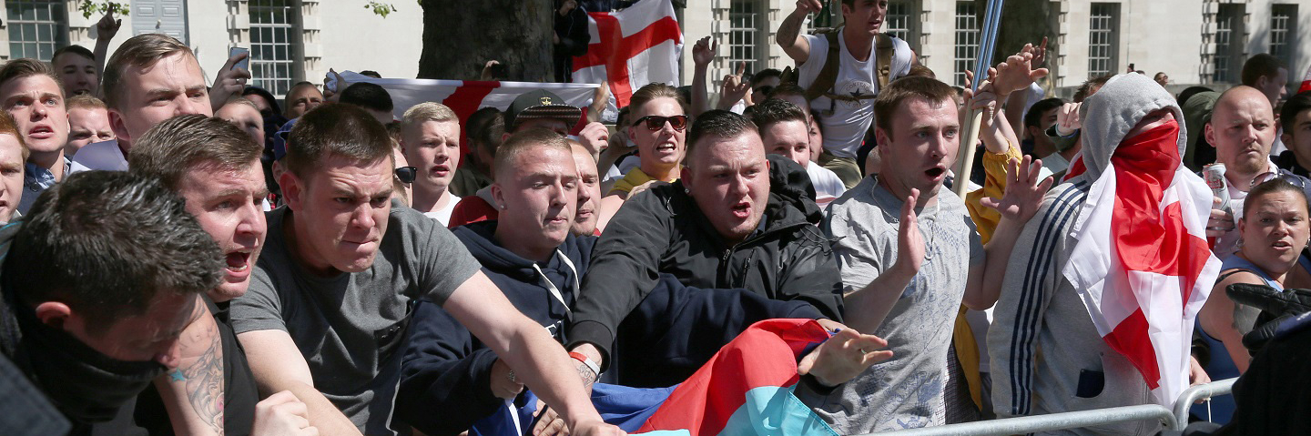 English Defence League (EDL) supporters try to reach anti fascist protestors during a rally outside Downing Street on May 27, 2013 in London, England.