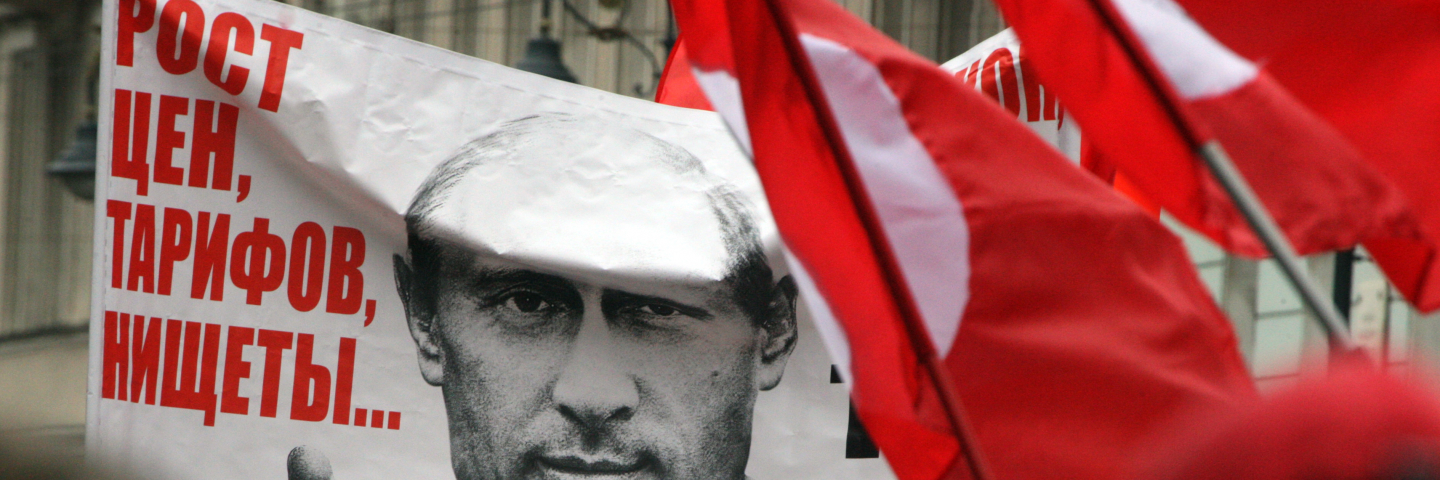 Opposition activists and supporters take part an anti-Putin protest the second Russia's city of Saint Petersburg, on September 15, 2012. The poster depicts Russian president Vladimir Putin and reads: "What have you elected is the rising prices and poverty!"
