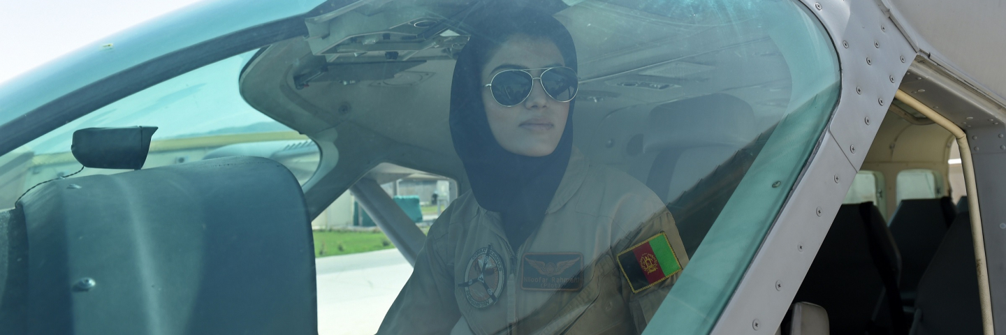 In a picture taken on April 26, 2015, Afghanistan's first female pilot Niloofar Rahmani, 23, sits in a fixed-wing Afghan Air Force aviator aircraft in Kabul. With a hint of swagger in her gait, Afghanistan's first female pilot since the ouster of the Taliban is defying death threats and archaic gender stereotypes to infiltrate an almost entirely male preserve.