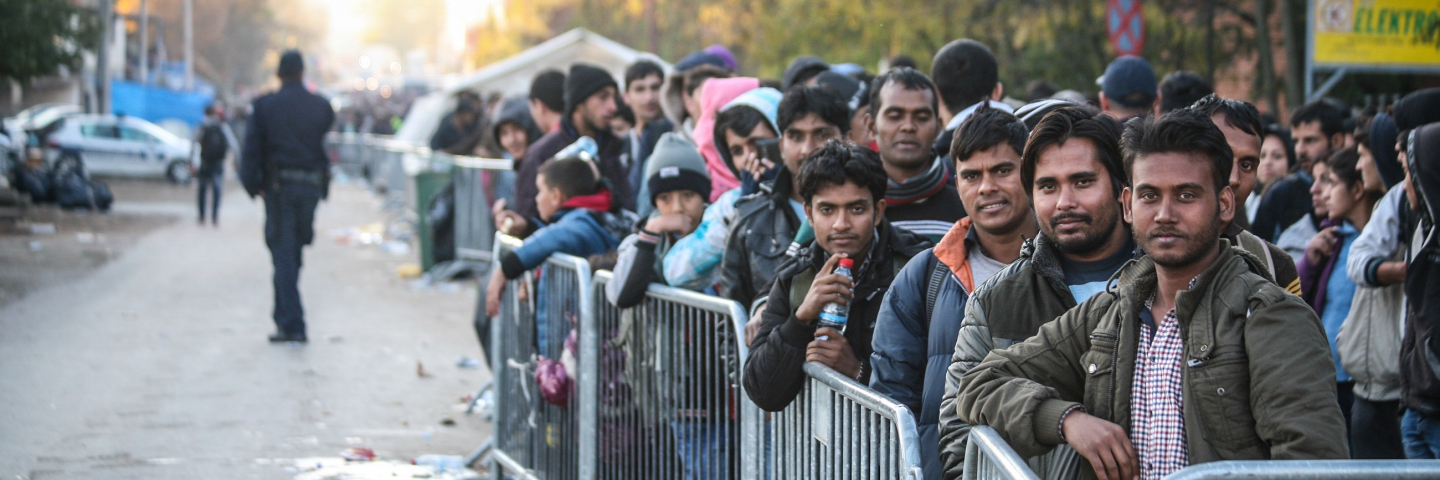 Asylum seekers wait to enter a transit camp after crossing the Macedonian-Serbian border. The United Nations says 210,000 asylum seekers transited through the Balkans in October in an effort to seek protection in Europe.