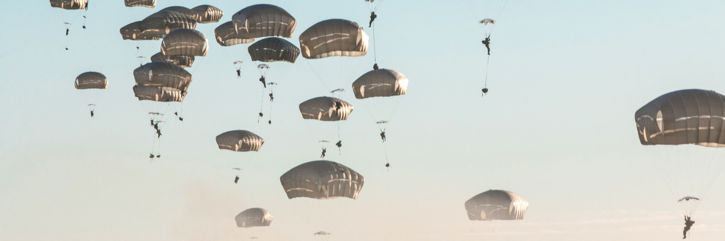 Paratroopers assigned to 82nd Airborne Division, Fort Bragg, NC, parachute onto a drop zone at Adazi Base, Latvia, from a C-17 Globemaster III during Swift Response 18, June 9, 2018.