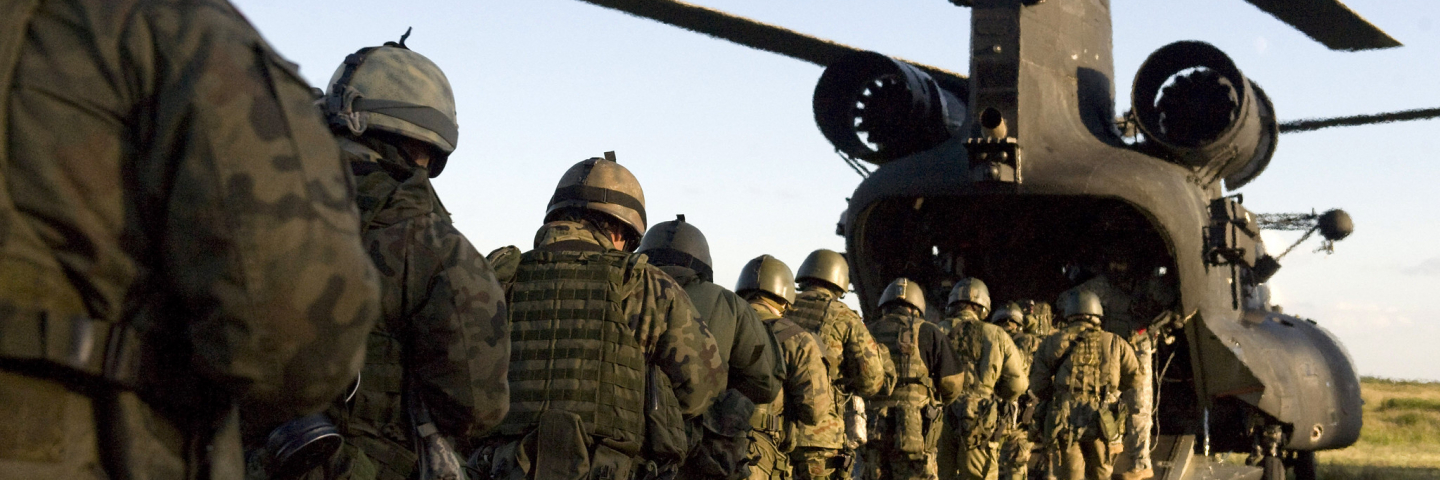 Special Operations Soldiers from Poland, Croatia, Romania and the U.S. prepare to board a MH-47 Chinook helicopter