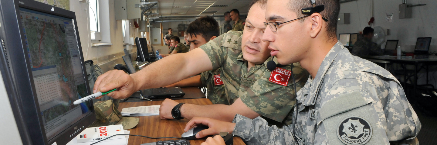 Us and Turkish soldiers work on computer monitoring