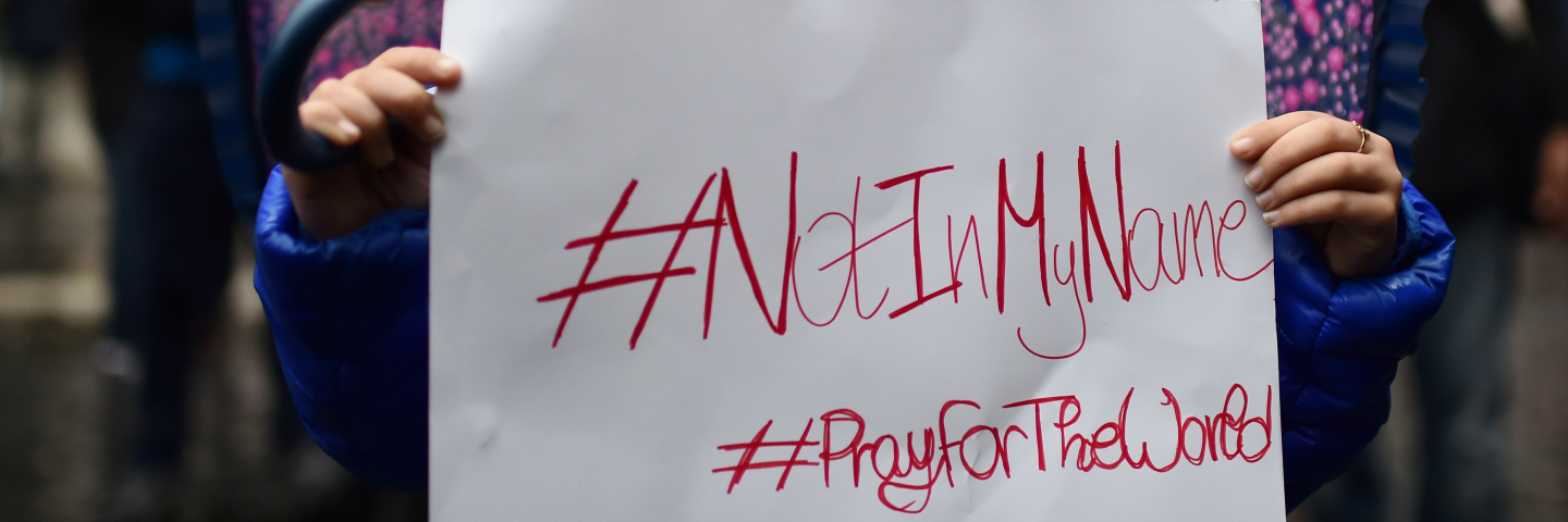 A little girl shows a placard reading "Not In my Name" during a demonstration of muslims to speak out against terrorism a week after Paris attacks, on November 21, 2015 in Rome. Hundreds of Muslims rallied in Rome and Milan on Saturday to show solidarity with the victims of jihadist attacks, condemning violence in the name of religion and chanting "we are not the enemy."