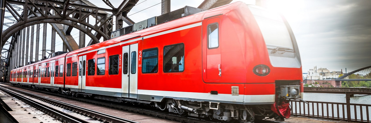 Photo of a passenger train passing on a bridge in Frankfurt, Germany.