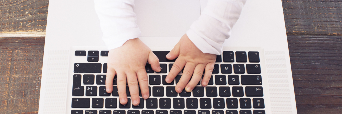 Little boy typing on laptop